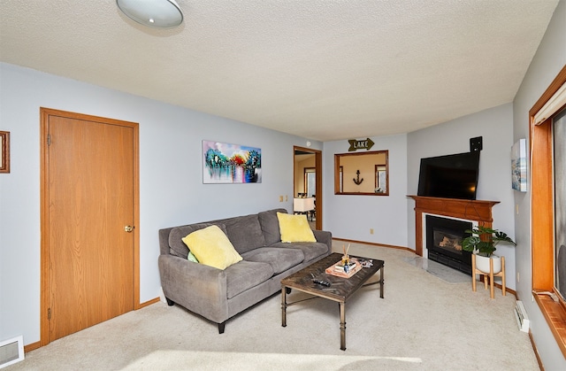 carpeted living room featuring a textured ceiling