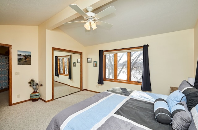 carpeted bedroom featuring ceiling fan, lofted ceiling with beams, and a closet