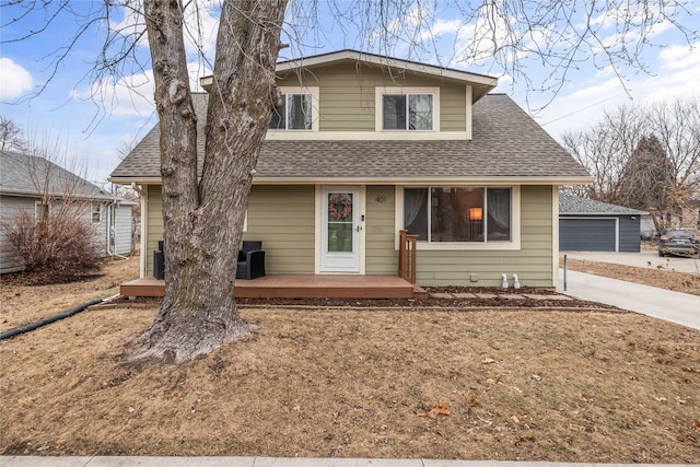 view of front of property with a garage and an outdoor structure