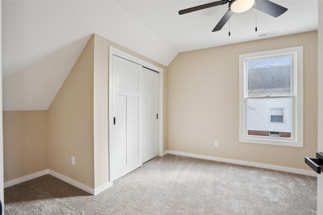 additional living space with ceiling fan, lofted ceiling, and carpet