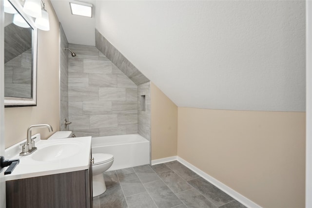 full bathroom with lofted ceiling, vanity, toilet, and tiled shower / bath combo