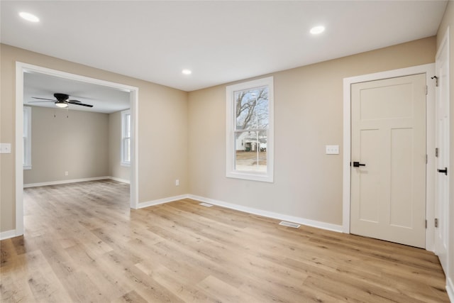 spare room featuring ceiling fan and light hardwood / wood-style flooring