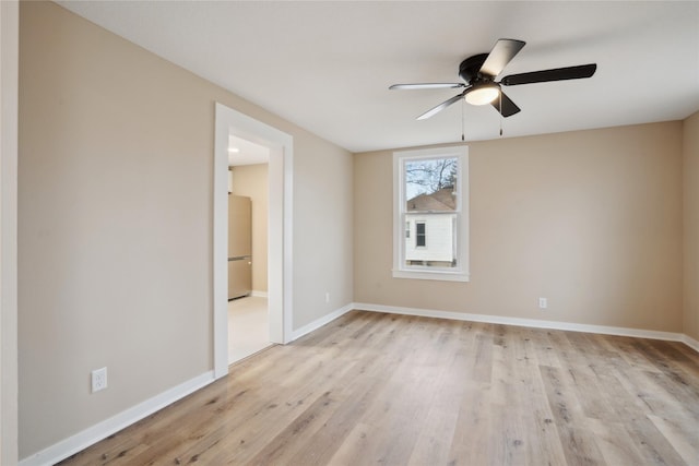 empty room with ceiling fan and light wood-type flooring