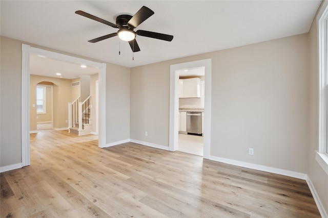 spare room featuring ceiling fan and light wood-type flooring