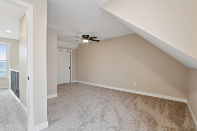 bonus room featuring light carpet, lofted ceiling, and ceiling fan