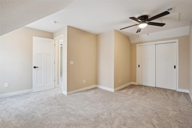 unfurnished bedroom featuring ceiling fan, a closet, and light carpet