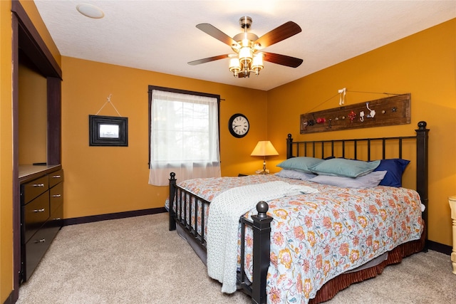 bedroom featuring ceiling fan and light carpet