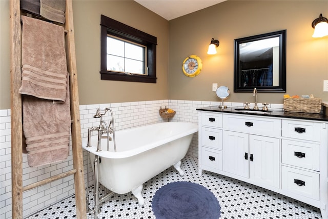 bathroom featuring tile patterned flooring, vanity, tile walls, and a bathtub