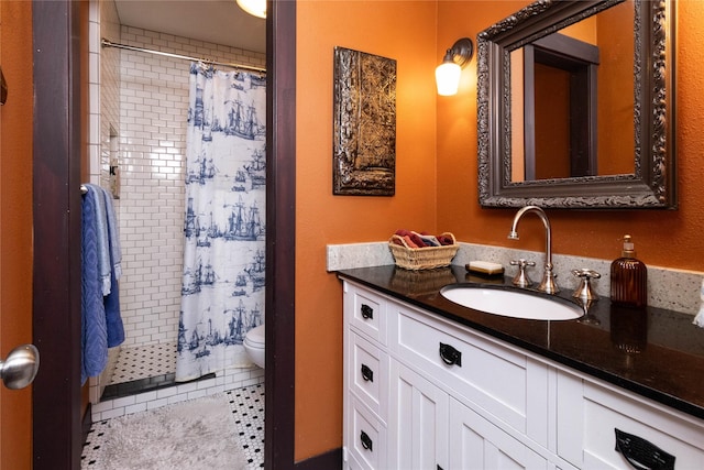 bathroom featuring vanity, toilet, curtained shower, and tile patterned flooring