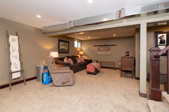 carpeted living room featuring a textured ceiling