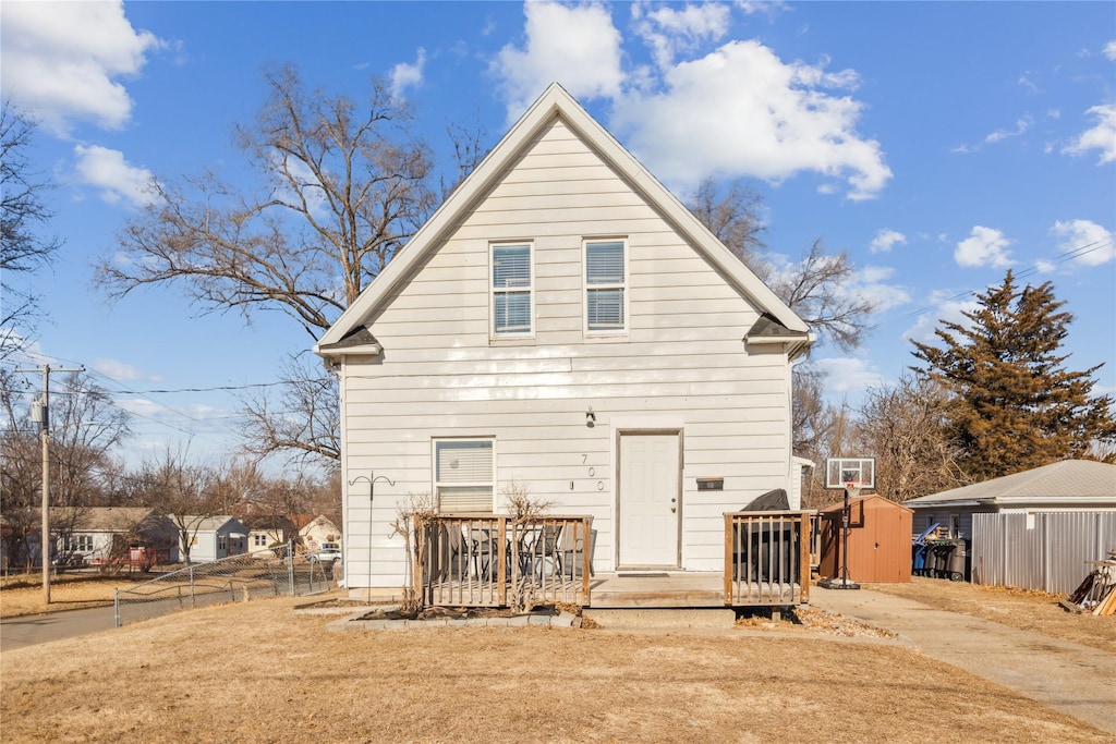 back of property featuring a storage shed