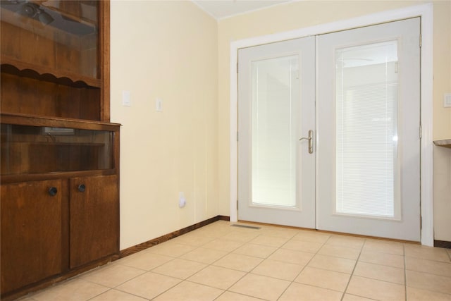 entryway featuring french doors and light tile patterned floors