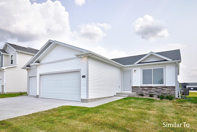 view of front facade with a garage, central AC unit, and a front yard