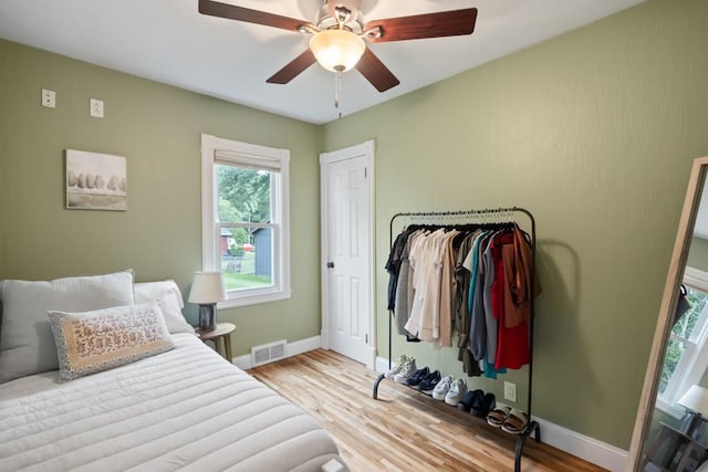 bedroom with ceiling fan and light wood-type flooring