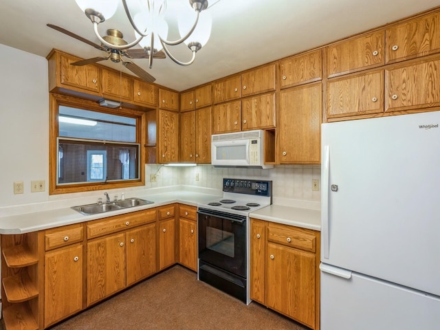 kitchen with pendant lighting, sink, white appliances, ceiling fan, and decorative backsplash