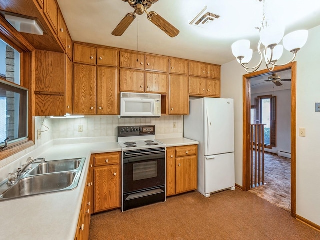 kitchen with sink, white appliances, backsplash, decorative light fixtures, and light colored carpet