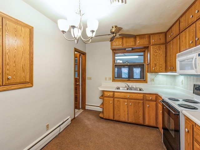 kitchen featuring pendant lighting, sink, electric range oven, and a baseboard heating unit