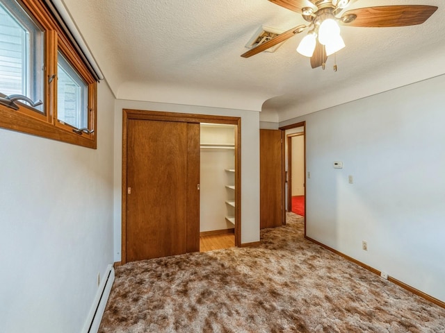 unfurnished bedroom with ceiling fan, light colored carpet, a closet, and a textured ceiling