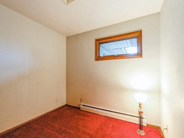 unfurnished room with dark colored carpet and a baseboard heating unit