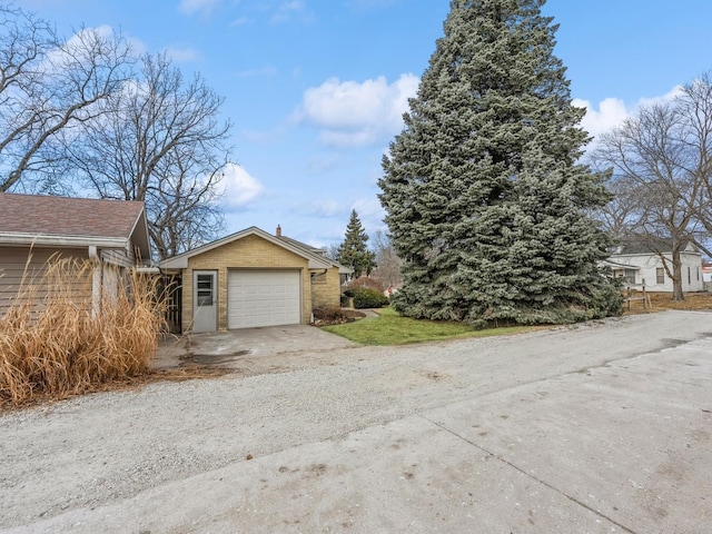 view of property exterior featuring a garage and an outdoor structure