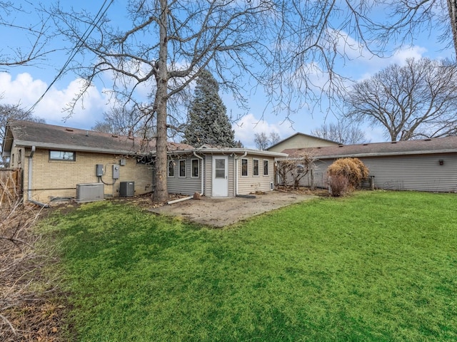 back of property featuring central AC, a yard, and a patio