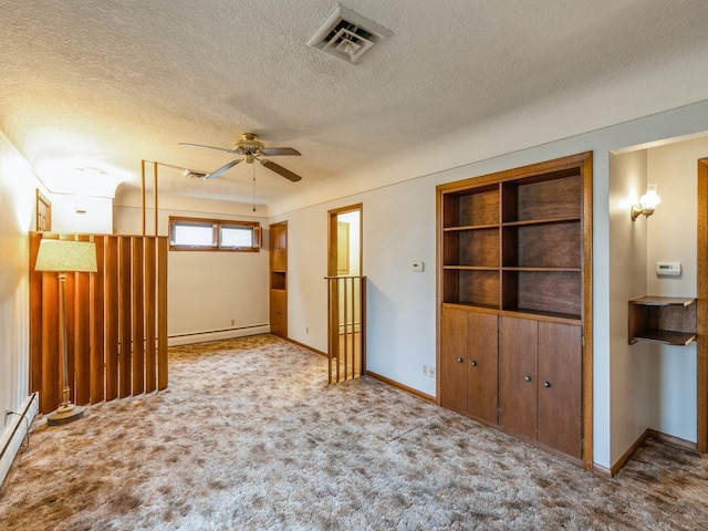 empty room featuring ceiling fan, a baseboard heating unit, light carpet, and a textured ceiling