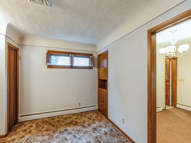 unfurnished bedroom with light colored carpet, a notable chandelier, a textured ceiling, and a baseboard heating unit