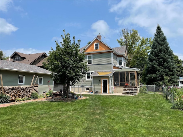 back of property featuring a yard and a sunroom