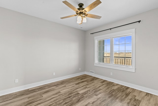 empty room with ceiling fan and light wood-type flooring