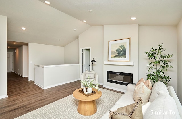 living room with dark hardwood / wood-style floors and vaulted ceiling