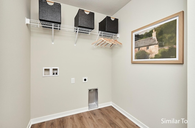 laundry room featuring wood-type flooring, hookup for a washing machine, and electric dryer hookup