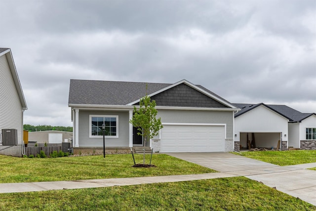 6433 NE 11th Ct, Des Moines, IA 50313 - view of front facade featuring concrete driveway, an attached garage, a front lawn, and stone siding