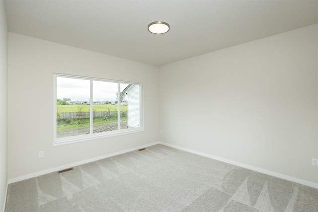 6433 NE 11th Ct, Des Moines, IA 50313 - spare room with light carpet and baseboards