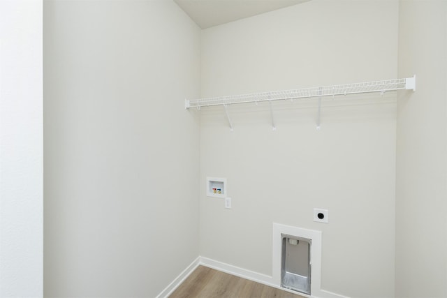 6433 NE 11th Ct, Des Moines, IA 50313 - laundry area featuring hookup for an electric dryer, washer hookup, baseboards, and light wood-style floors