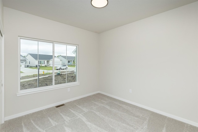 6433 NE 11th Ct, Des Moines, IA 50313 - unfurnished room featuring light colored carpet and baseboards