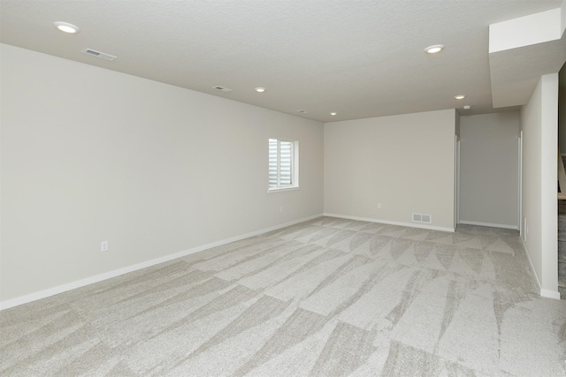 6433 NE 11th Ct, Des Moines, IA 50313 - spare room featuring light colored carpet, baseboards, and recessed lighting