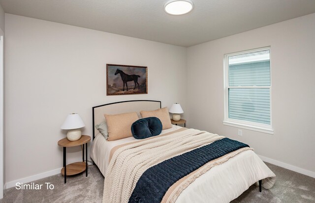 carpeted bedroom featuring baseboards