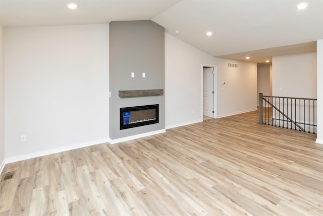 unfurnished living room featuring light wood finished floors, visible vents, and recessed lighting