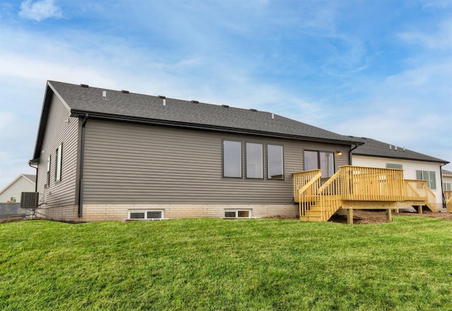 back of property featuring a wooden deck, cooling unit, and a lawn