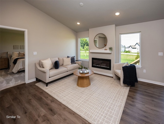 6443 NE 11th Ct, Des Moines, IA 50313 - living area with vaulted ceiling, dark wood-type flooring, baseboards, a glass covered fireplace, and recessed lighting