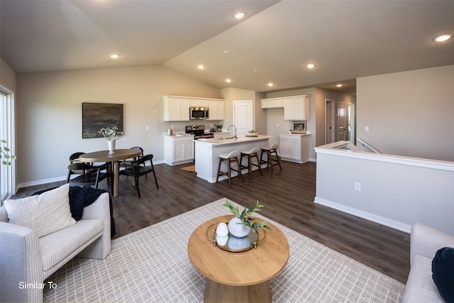 6443 NE 11th Ct, Des Moines, IA 50313 - living area with dark wood finished floors, baseboards, vaulted ceiling, and recessed lighting