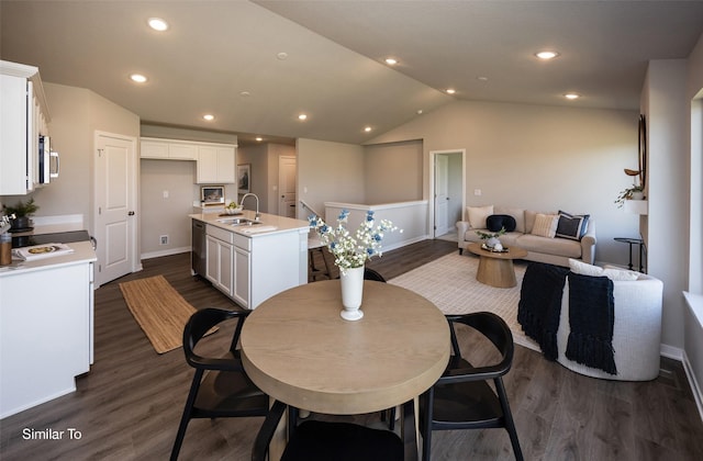 dining space featuring lofted ceiling, dark hardwood / wood-style floors, and sink