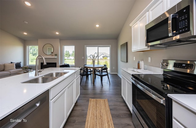 kitchen with sink, plenty of natural light, stainless steel appliances, and white cabinets