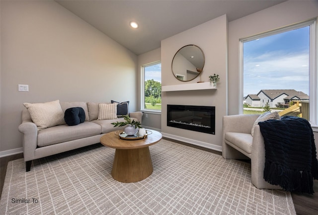 living room featuring light hardwood / wood-style flooring and vaulted ceiling