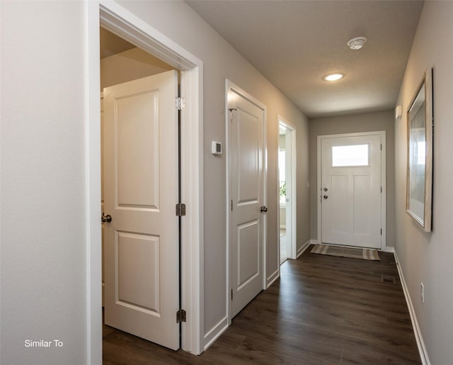 doorway to outside with dark hardwood / wood-style floors