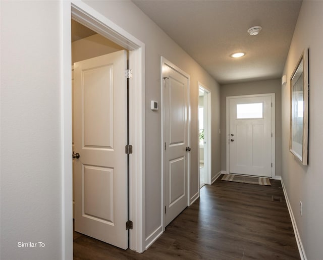 6443 NE 11th Ct, Des Moines, IA 50313 - foyer featuring dark wood finished floors and baseboards