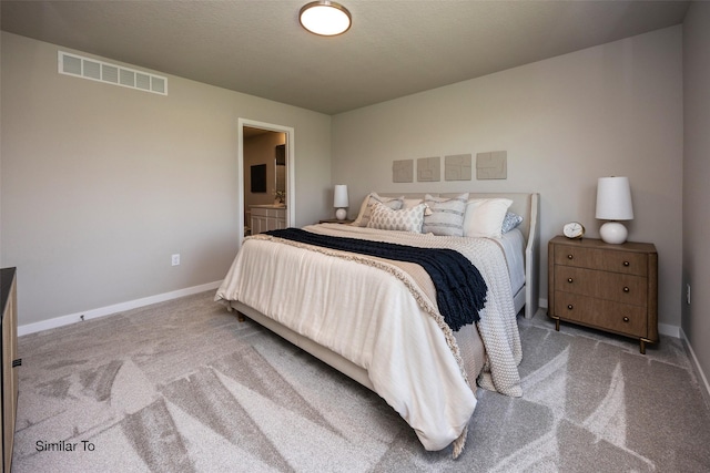 bedroom featuring carpet and connected bathroom