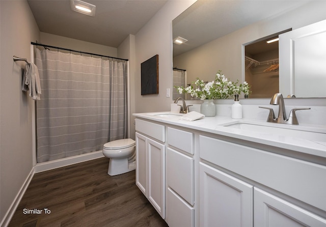 bathroom featuring hardwood / wood-style flooring, vanity, toilet, and a shower with curtain