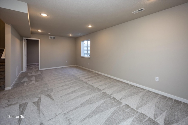 6443 NE 11th Ct, Des Moines, IA 50313 - carpeted spare room featuring baseboards, stairway, and recessed lighting