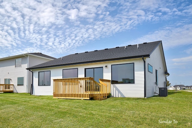 rear view of property with a wooden deck, central AC, and a lawn